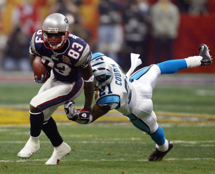 New England Patriots wide receiver Deion Branch (L) breaks away from Terry Cousins (R) of the Carolina Panthers in the first quarter of Super Bowl XXXVIII at Reliant Stadium 01 February 2004 in Houston, TX