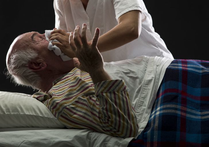 A man forces a patient to inhale chloroform