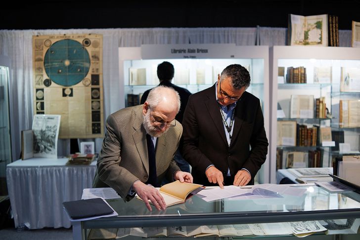 Two men at the Park Avenue Armory during the New York Antiquarian Book Fair in 2013 Two men at the Park Avenue Armory during the New York Antiquarian Book Fair in 2013
