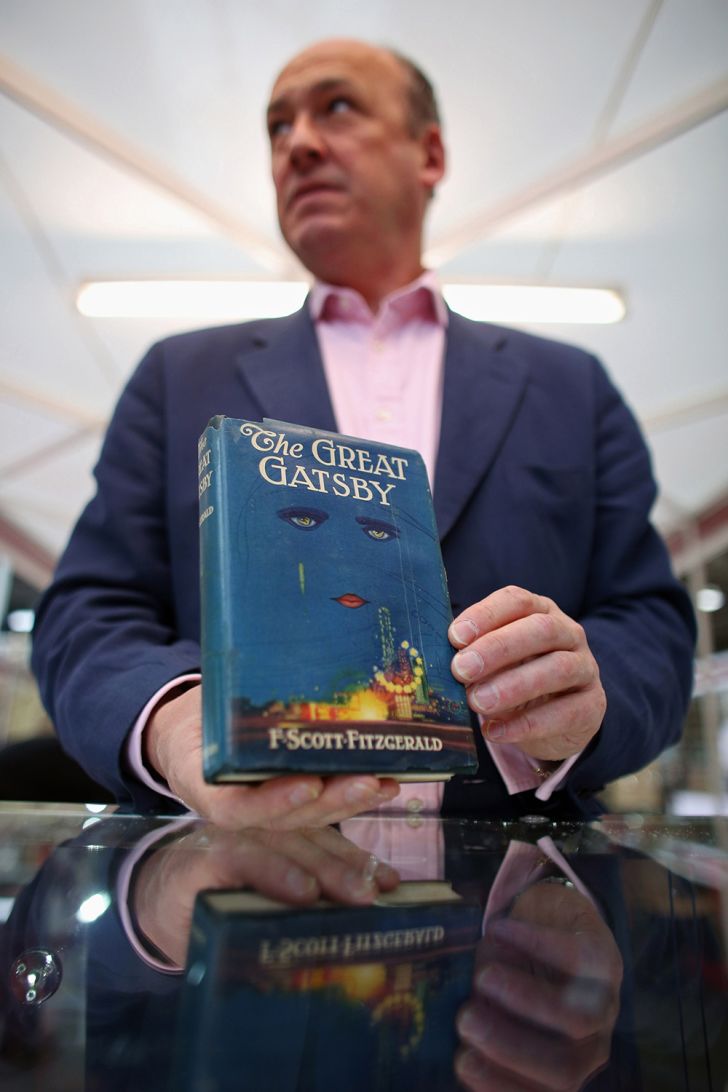 A bookseller holding a first edition of The Great Gatsby at the London International Antiquarian Book Fair in 2013 A bookseller holding a first edition of The Great Gatsby at the London International Antiquarian Book Fair in 2013