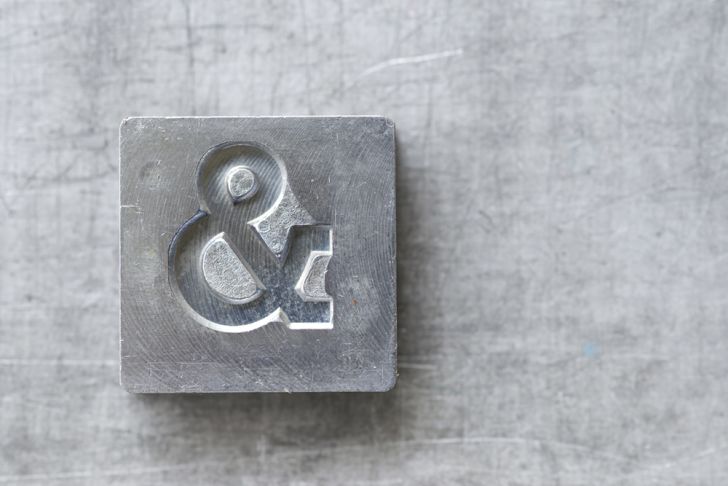 Ampersand symbol on an old metal block