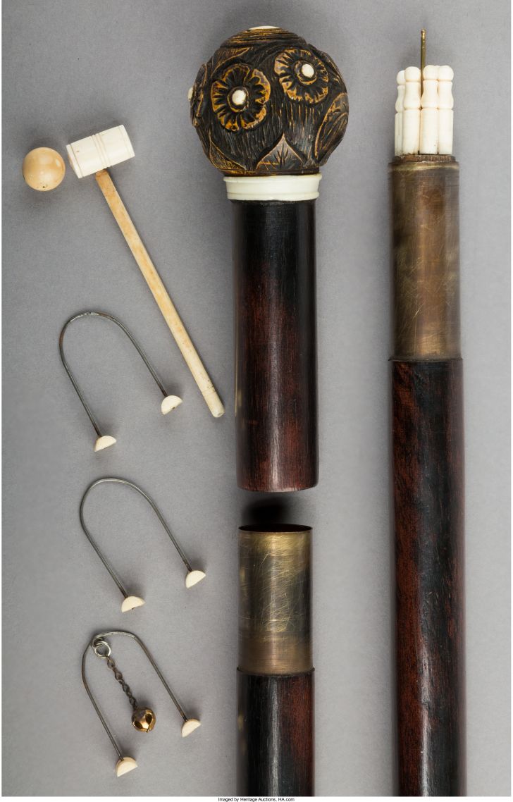 Cane with miniature croquet set.