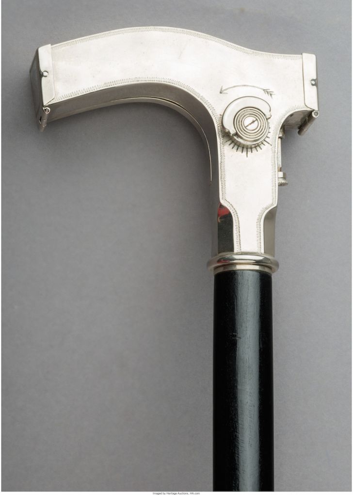 Chrome handle of a cane.