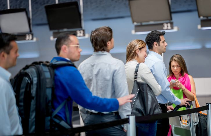 people standing in a single-file line at airport security