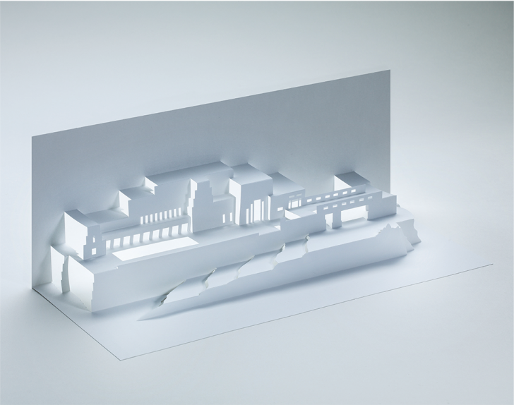 A white paper cut-out of Frank Lloyd Wright's Ennis House design