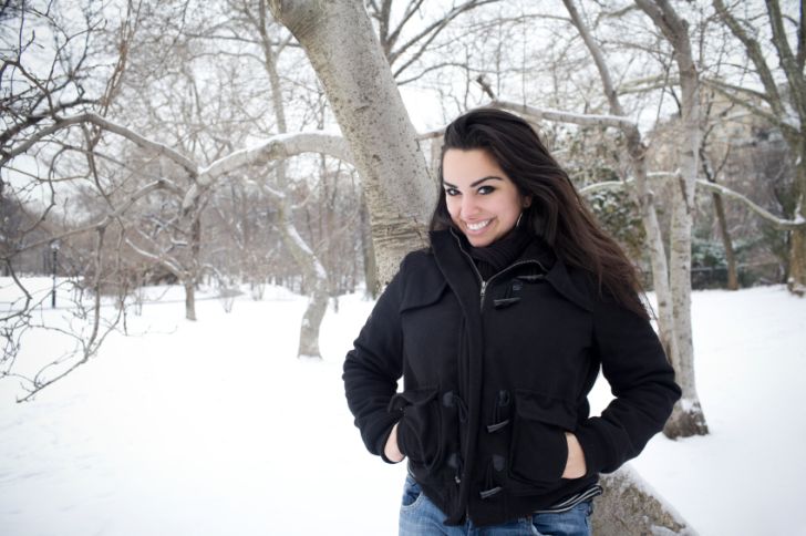 Woman with hands in her coat pockets in a wintry landscape Woman with hands in her coat pockets in a wintry landscape