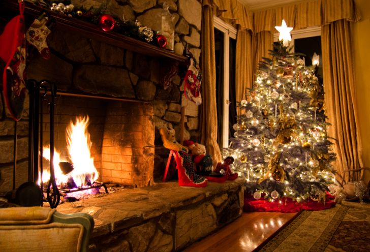 A warm fireplace and Christmas tree in a rustic home A warm fireplace and Christmas tree in a rustic home