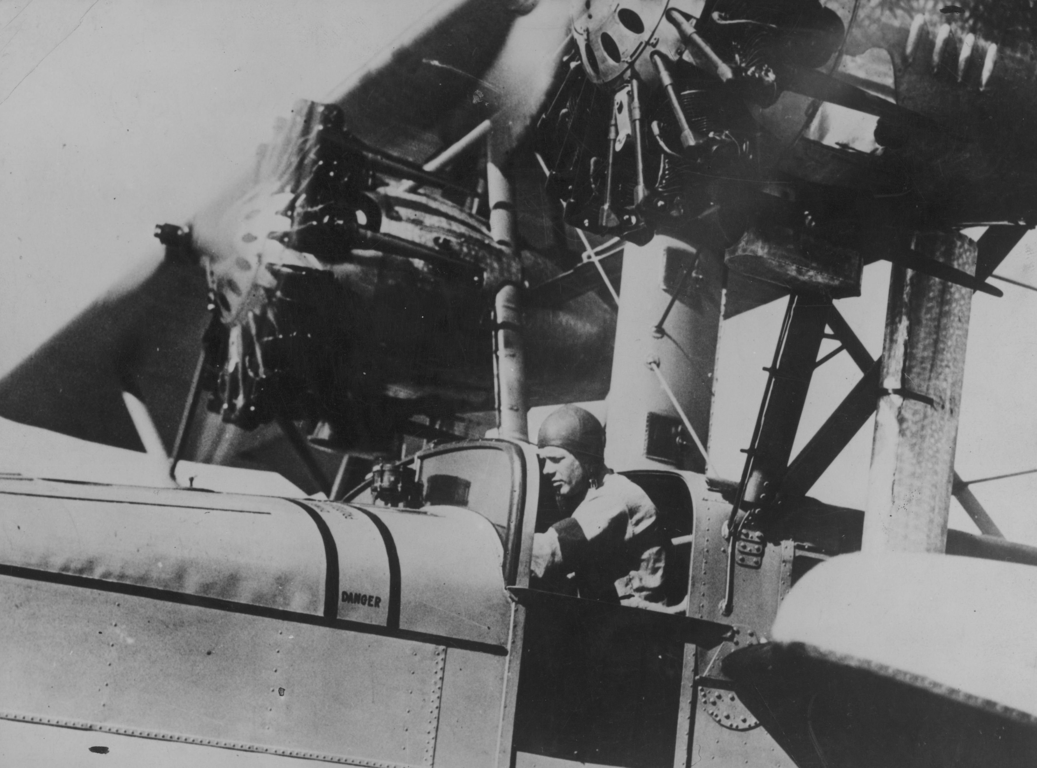 Black and white photo of pilot Charles Lindbergh in the cockpit of a postal plane.